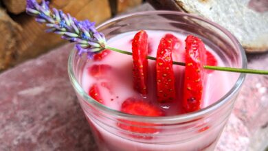 Ein Lavendelzweig mit drei aufgespießten Erdbeerscheiben verpassen dem Dessert einen zusätzlichen Pfiff.