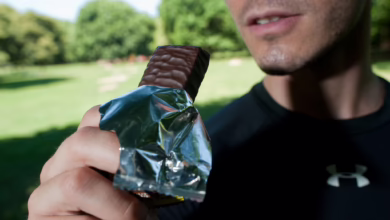 Mann Isst Nach Dem Lauftraining Einen Proteinriegel