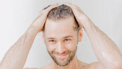 Mann steht unter einer dusche