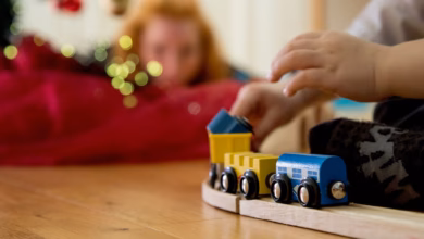 Ein kind spielt mit einer holzeisenbahn